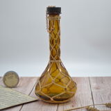 Amber decanter with wicker and golden chain