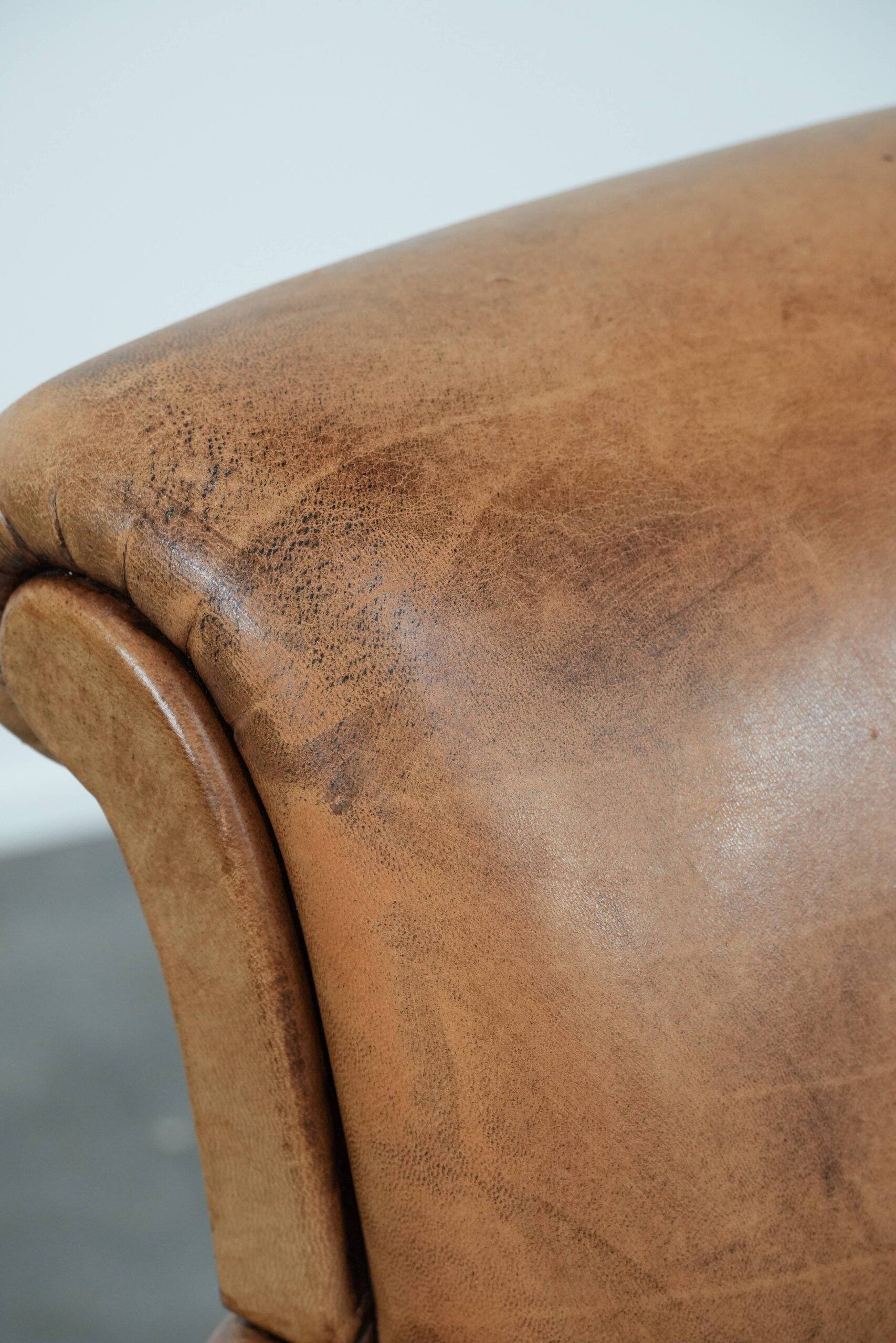 Beautiful subtle vintage sheepskin armchair with elegant legs