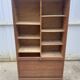 Oak two-column filing cabinet with curtains.