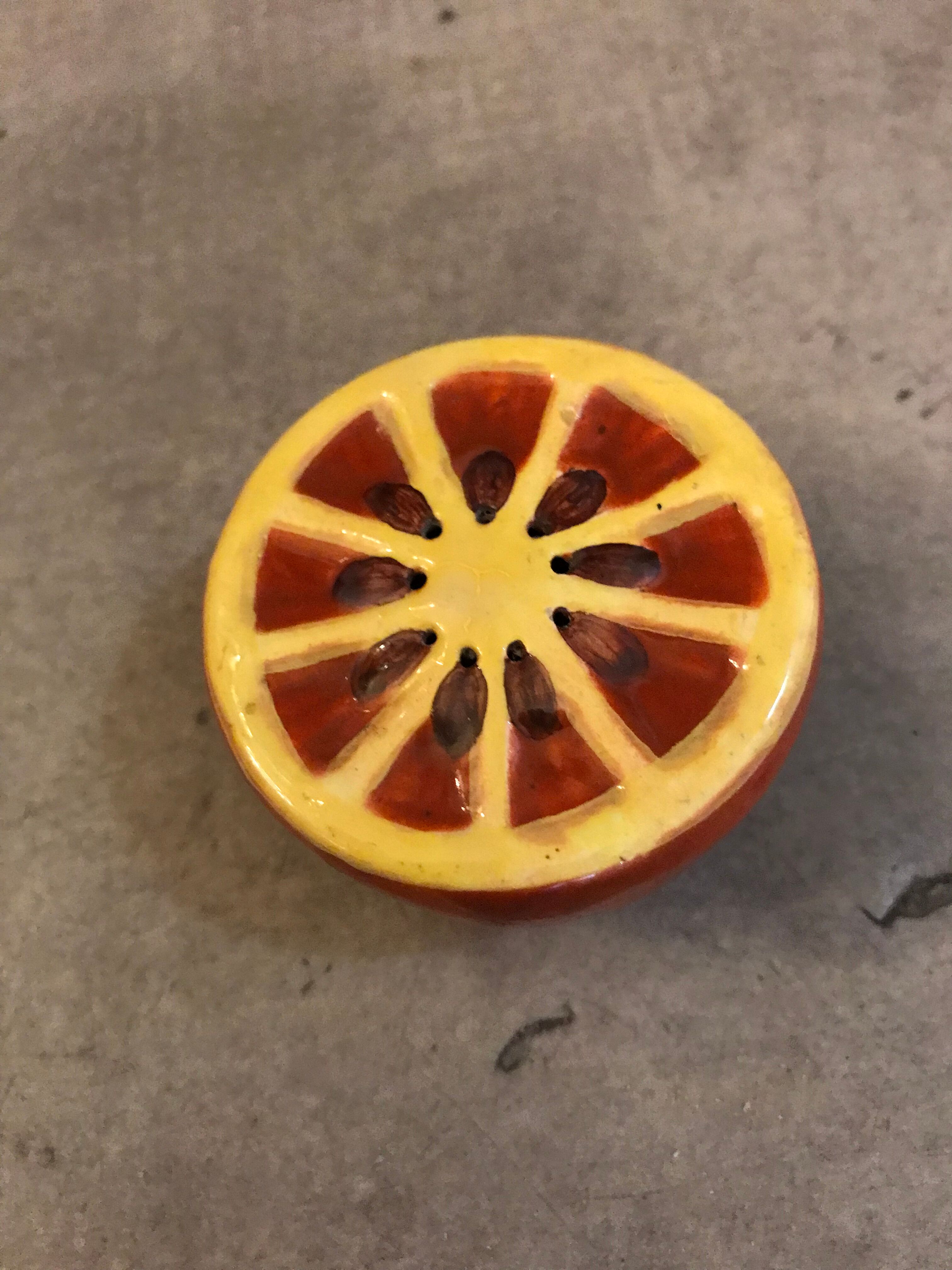 Vintage salt shaker in the shape of an orange marked ermetic