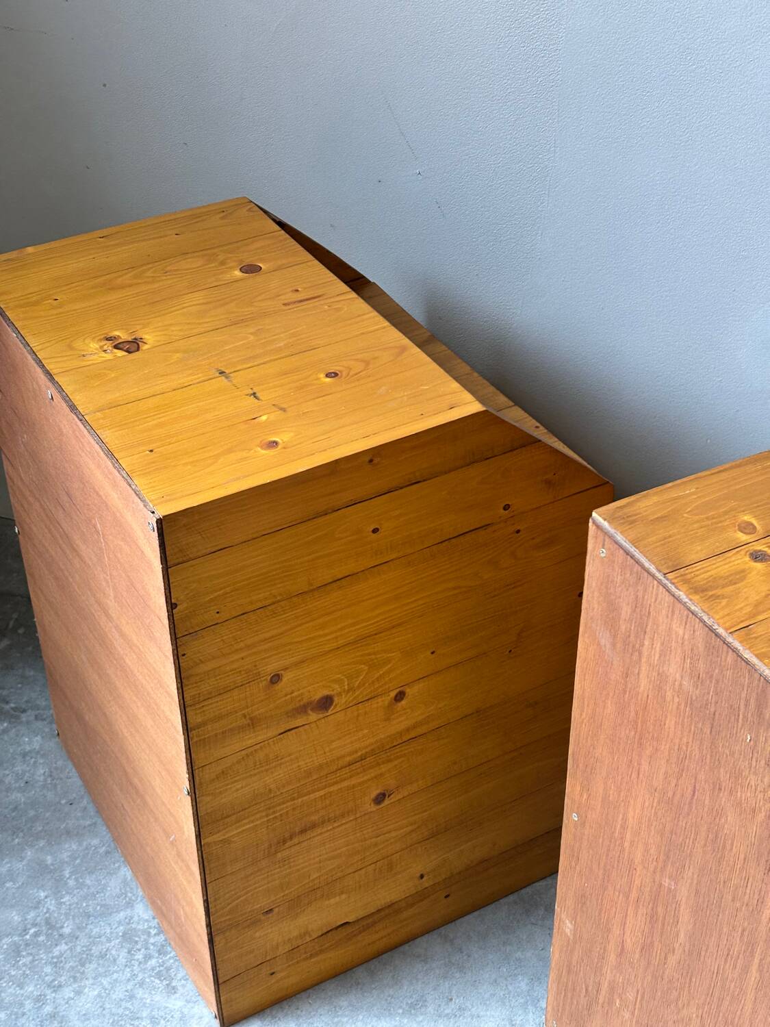 Pair of handcrafted solid wood bedside tables with drop-down doors.