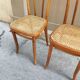 Pair of vintage bistro chairs in curved wood and caning.