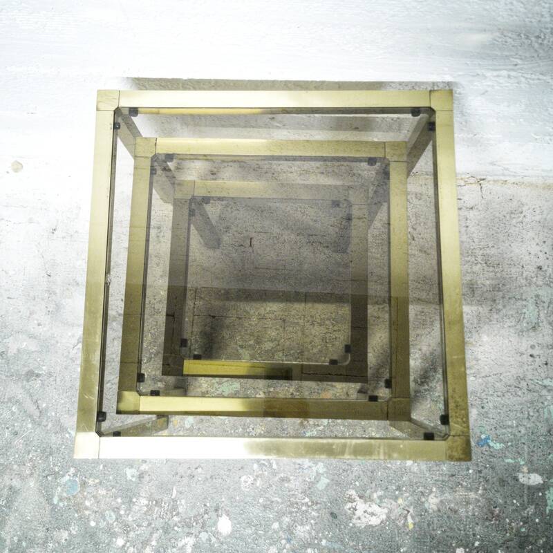 Trio of nesting tables in brass and smoked glass