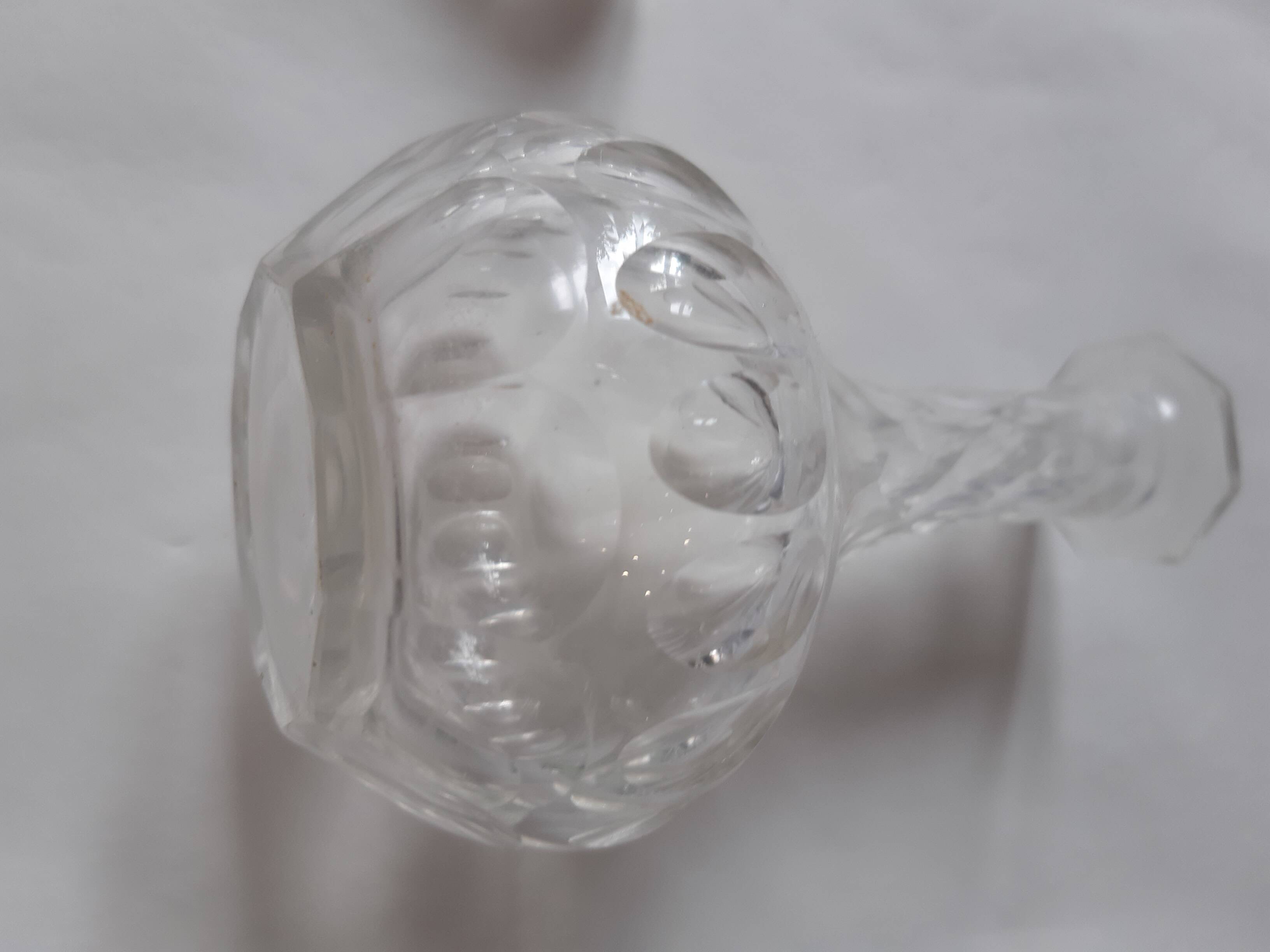 Cut crystal oil bottle with its crystal stopper.