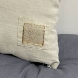 Cushion in vintage fabric with ornamentation