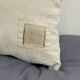 Cushion in vintage fabric with ornamentation.