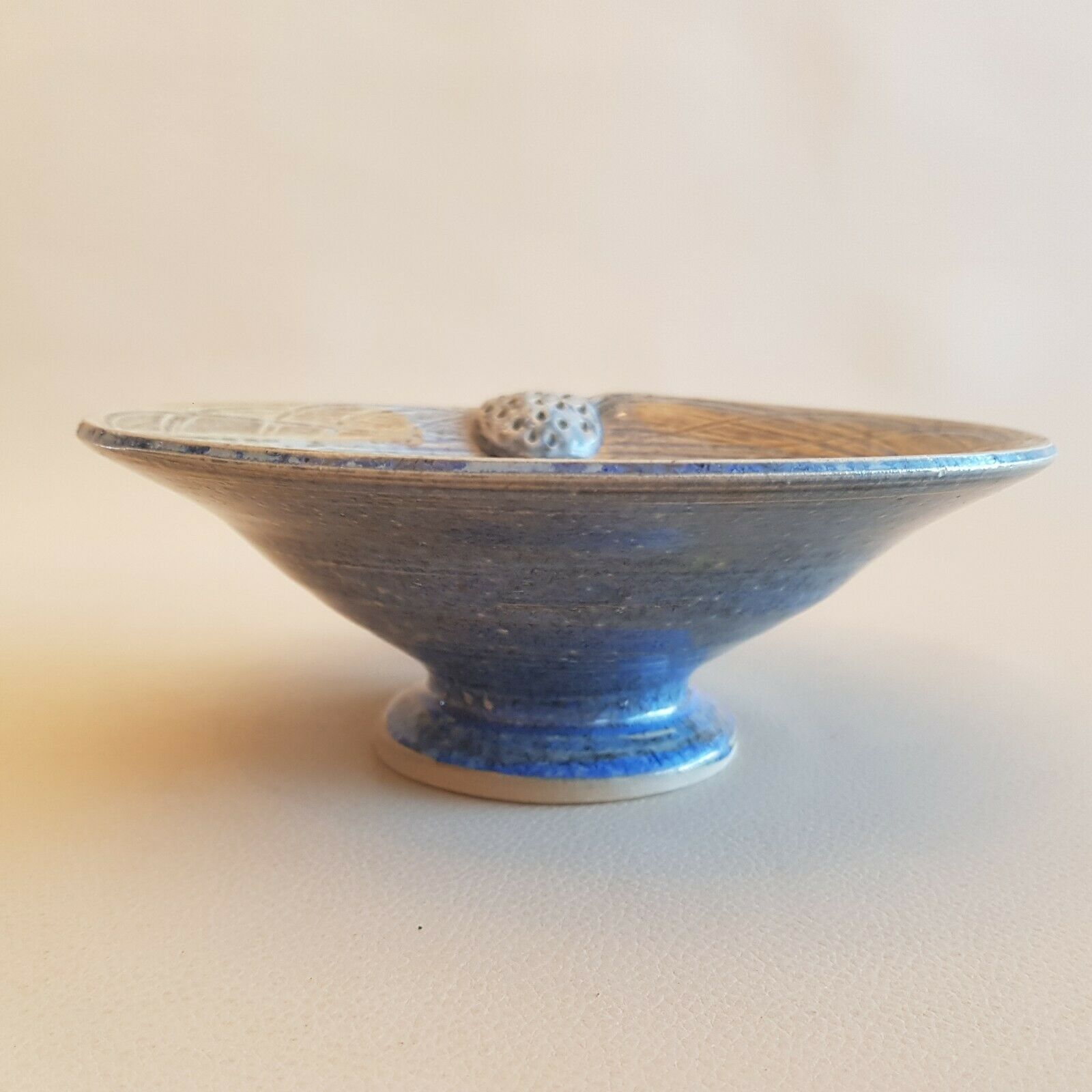 Empty pocket bowl cup on ceramic pedestal with signed spike holes