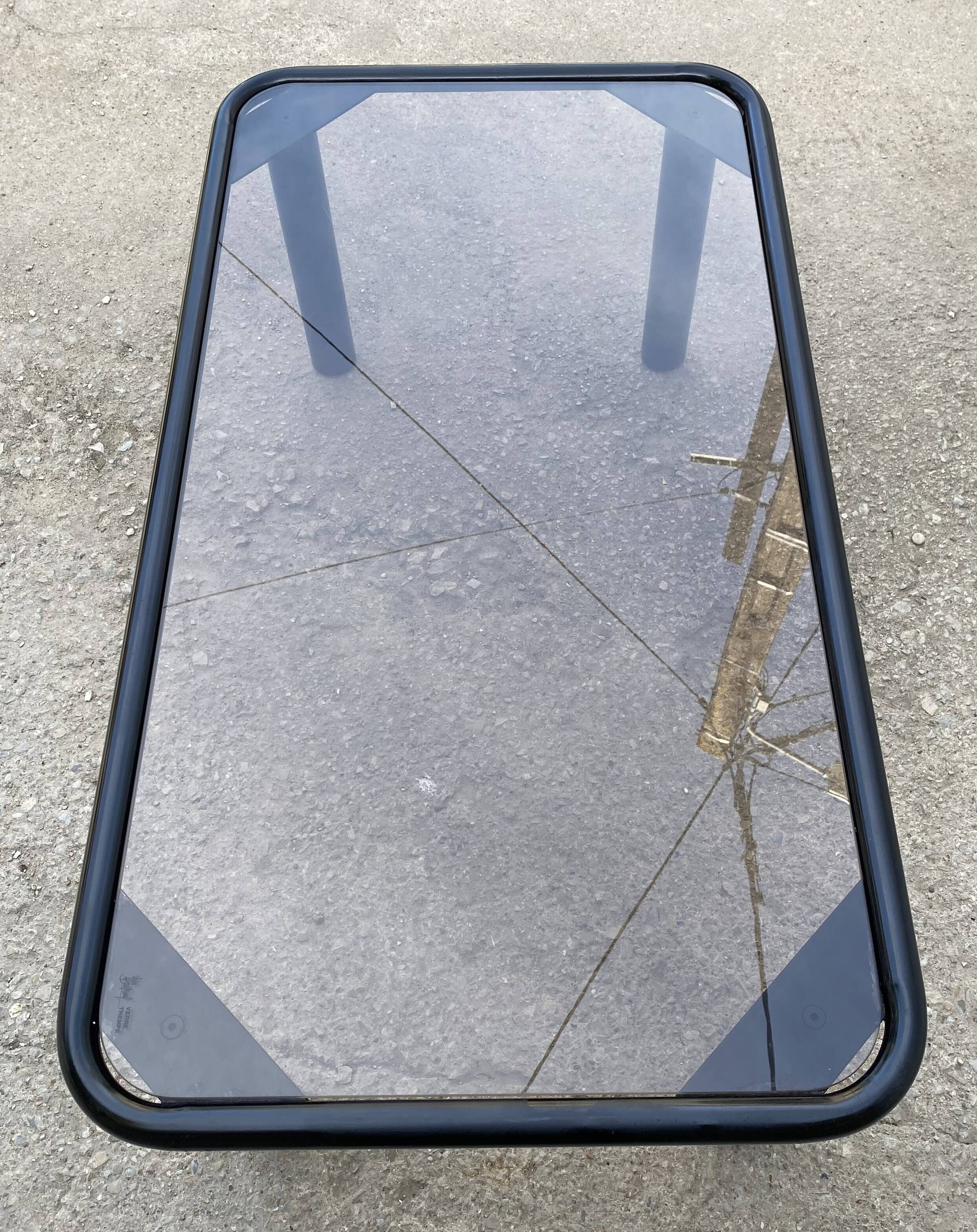 Black tubular coffee table with smoked glass by Yves Boutboul, 1980.