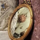 Oval mirror in gilded wood, 31x21 cm