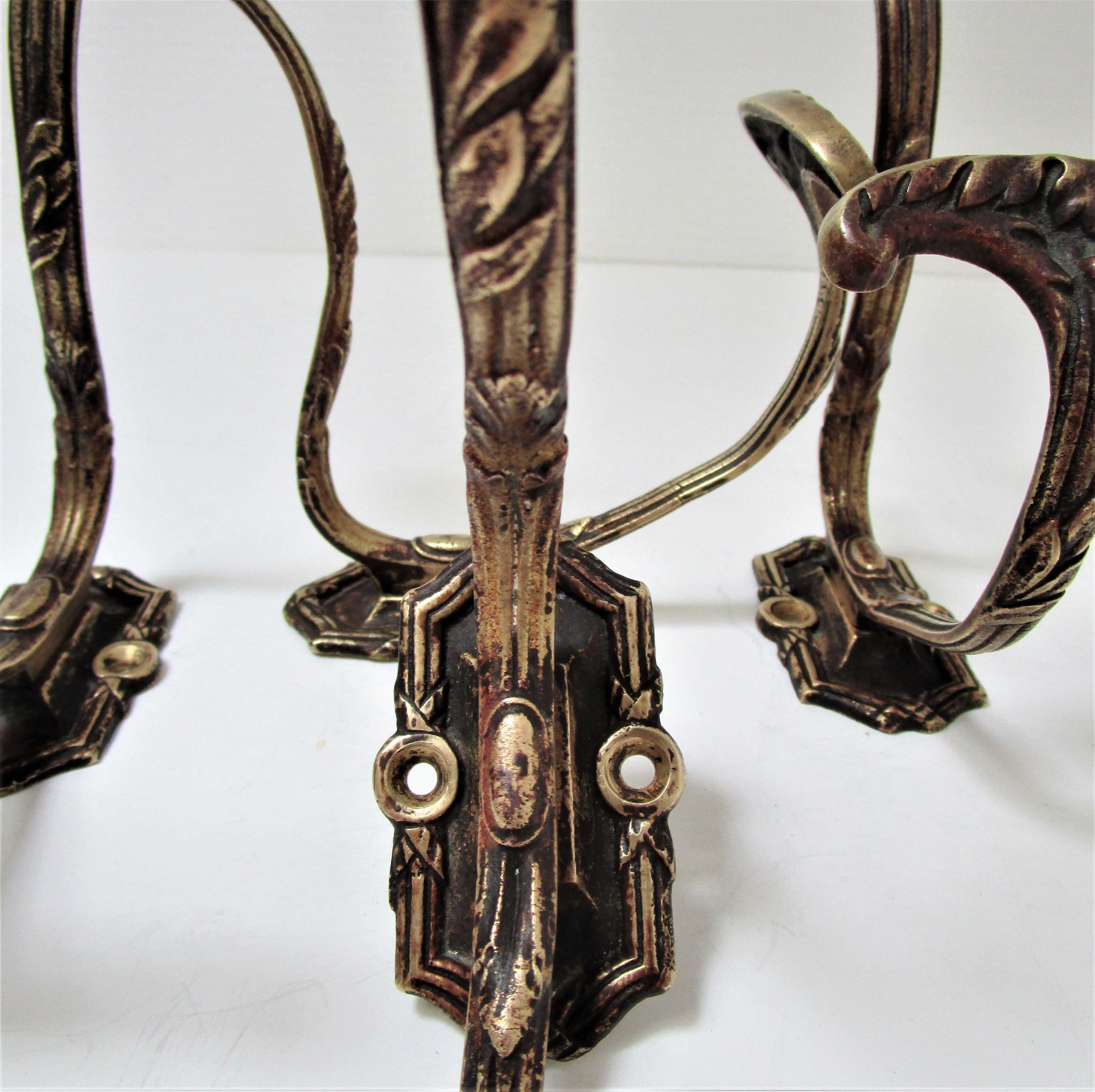 Four patères bronze patinated leafy décor early 20th century