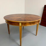 Round walnut Napoleon III extendable table with bronze top in good condition.