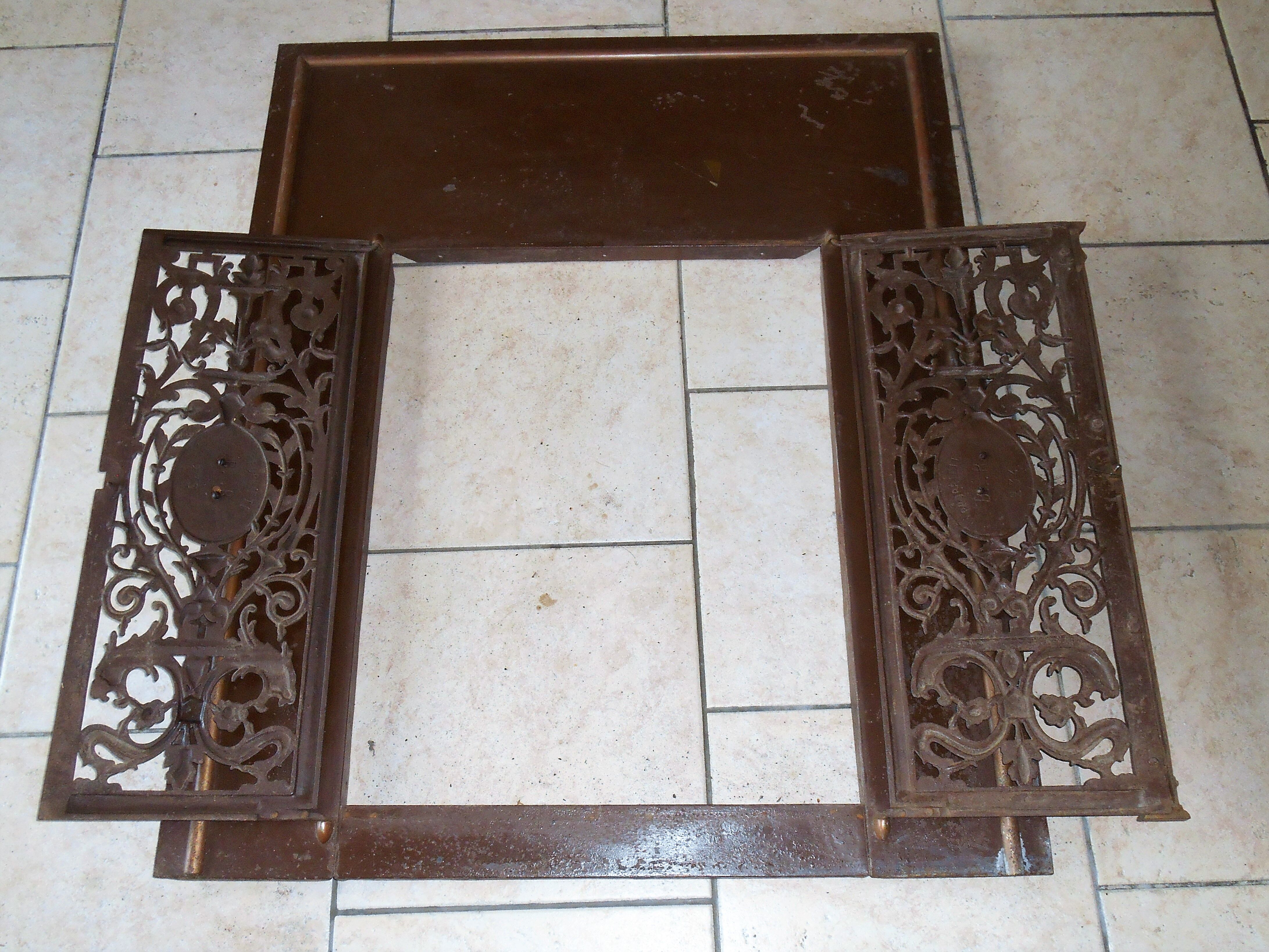 Pair of cast iron door grilles with its coat