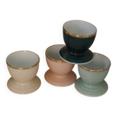 Four coloured egg cups with a golden rim from the 50s.