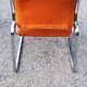 Pair of designer armchairs in orange fabrics and chrome tubes from the 70s