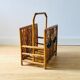 Vintage rattan magazine holder with floral decoration
