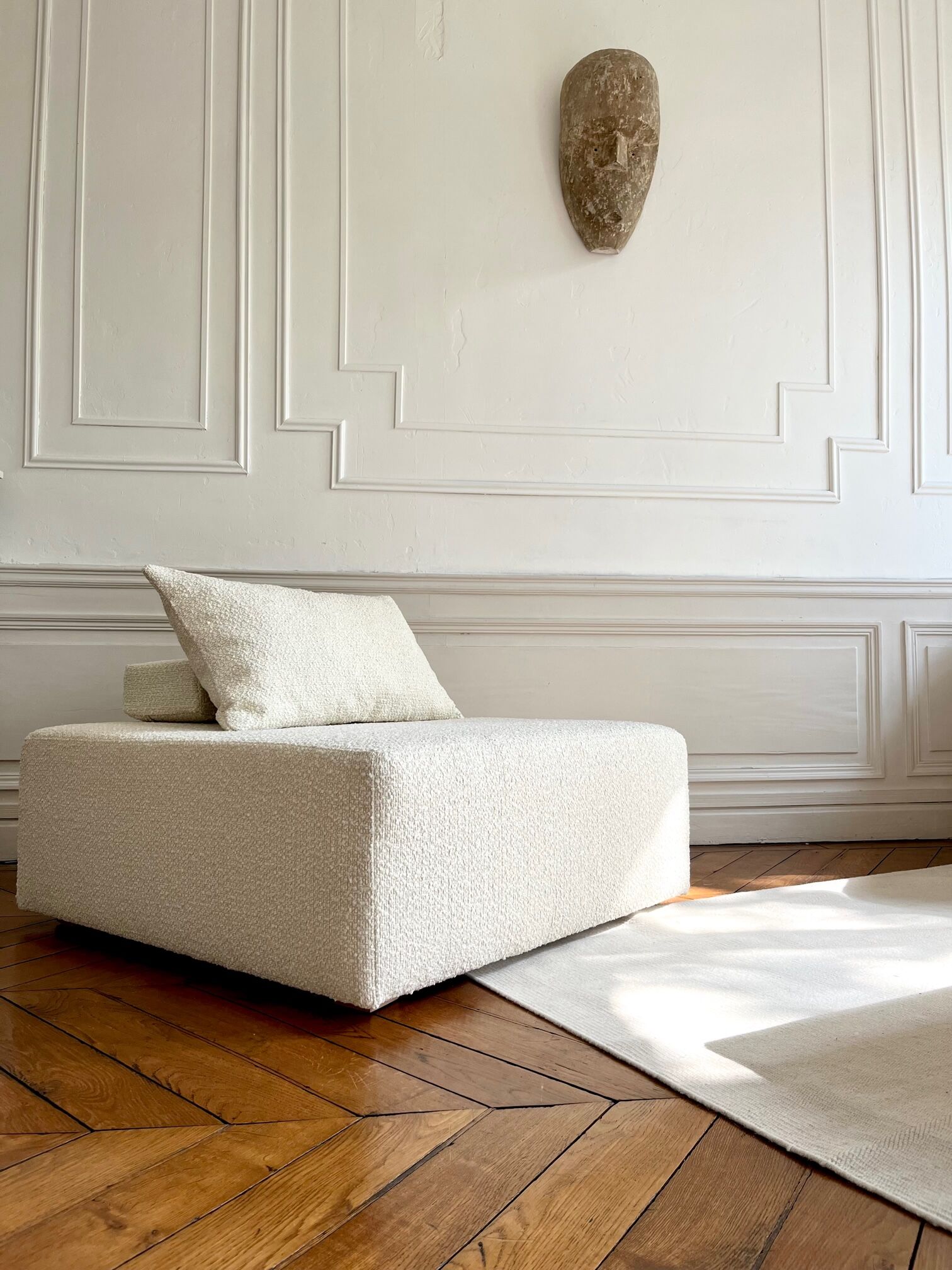 Square ottoman and its cushions in buckle fabric