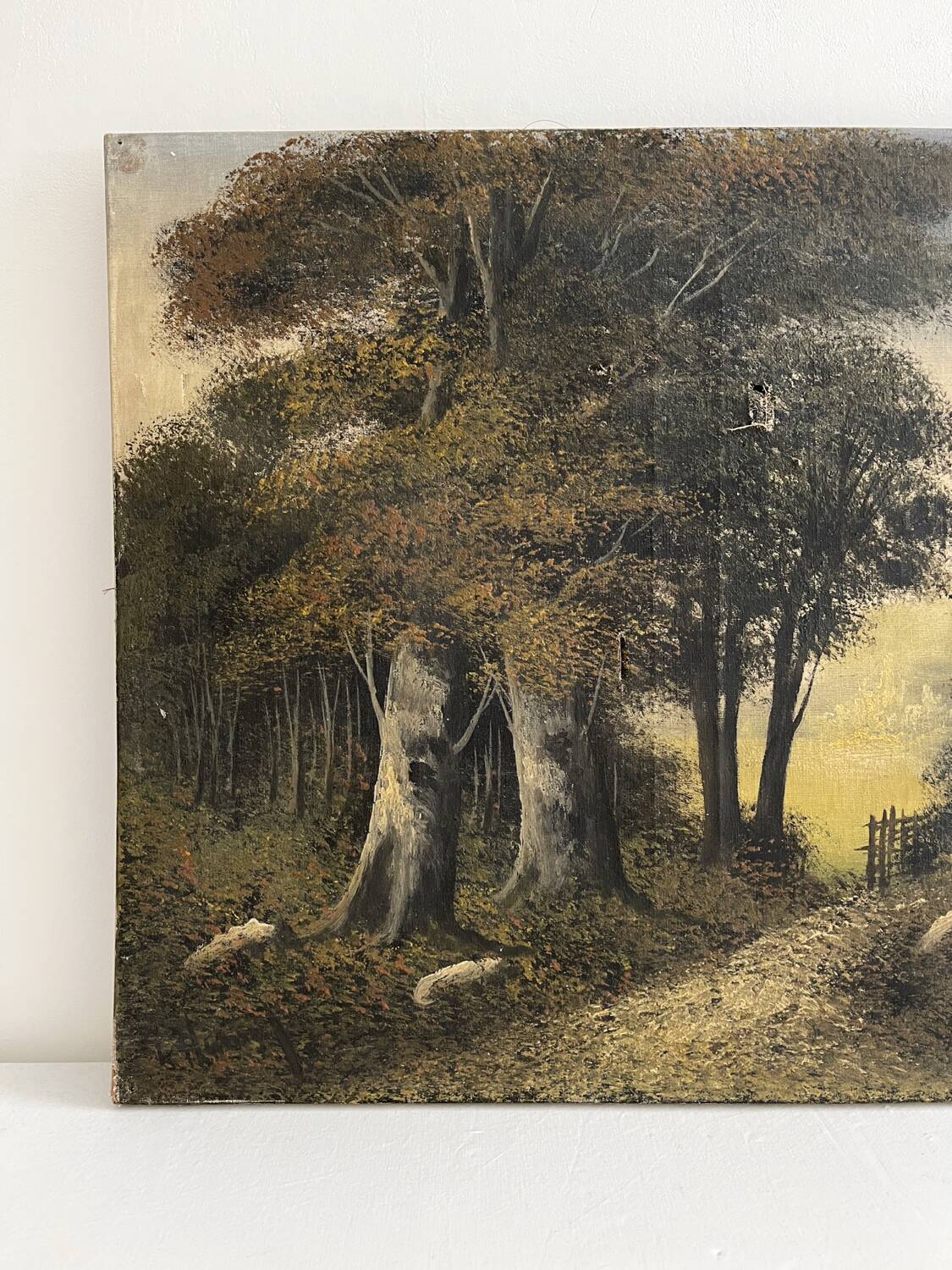 Old oil painting on canvas of a forest landscape.
