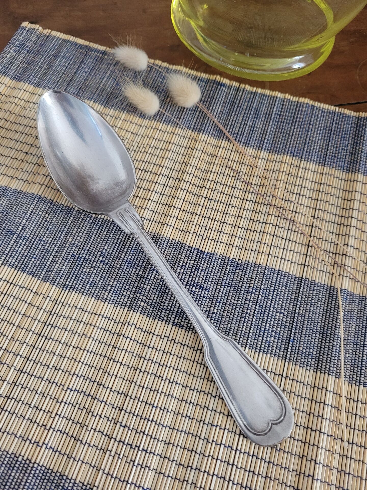 Large silver spoon with net decoration.