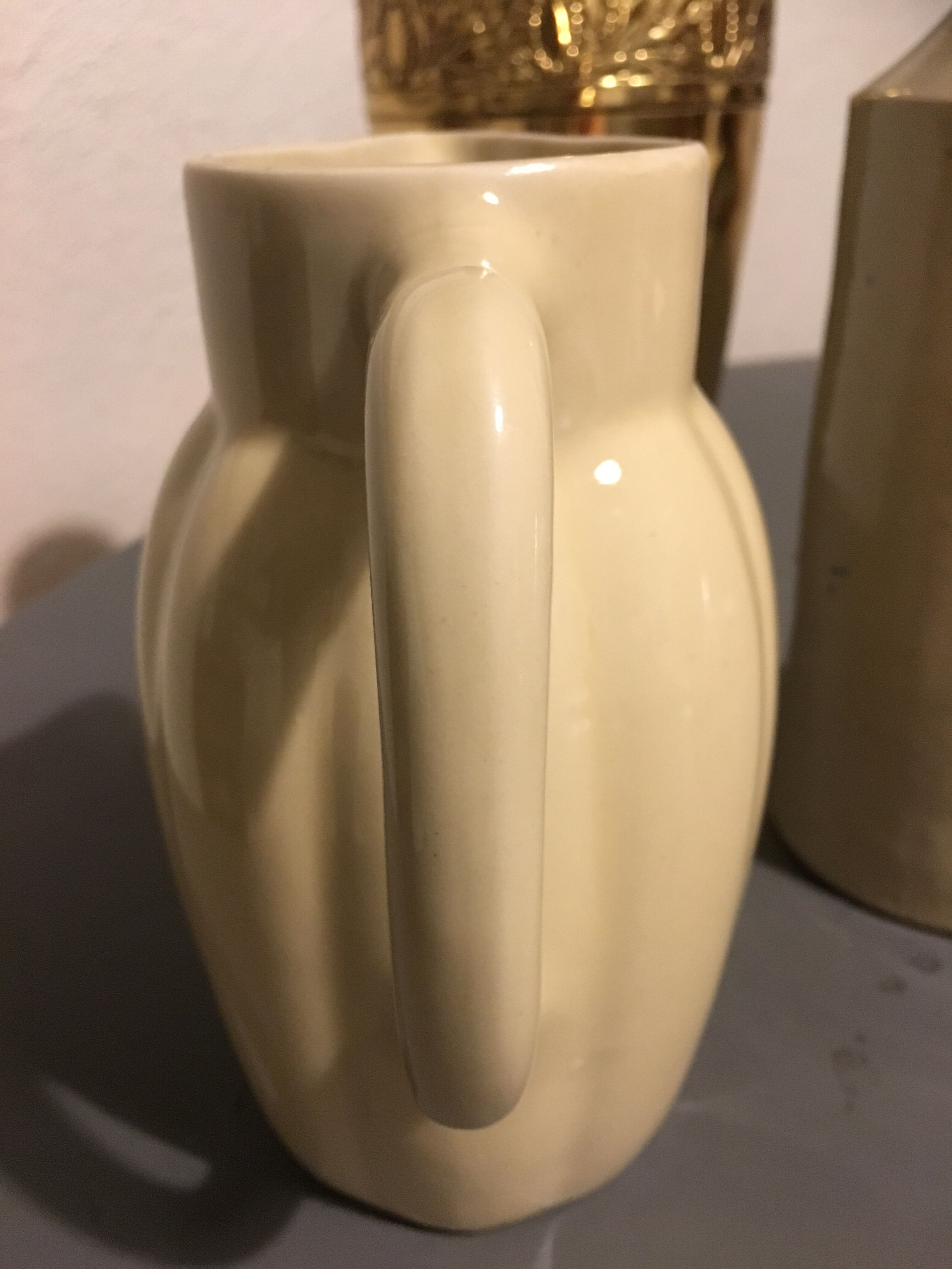 Cream color earthenware pitcher