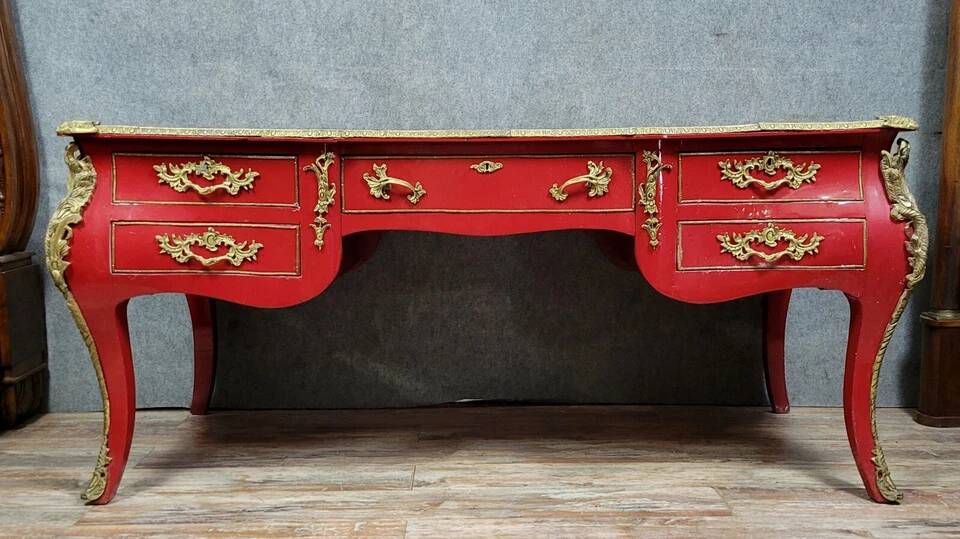 Louis XV style curved center desk in red lacquer and gilded bronze