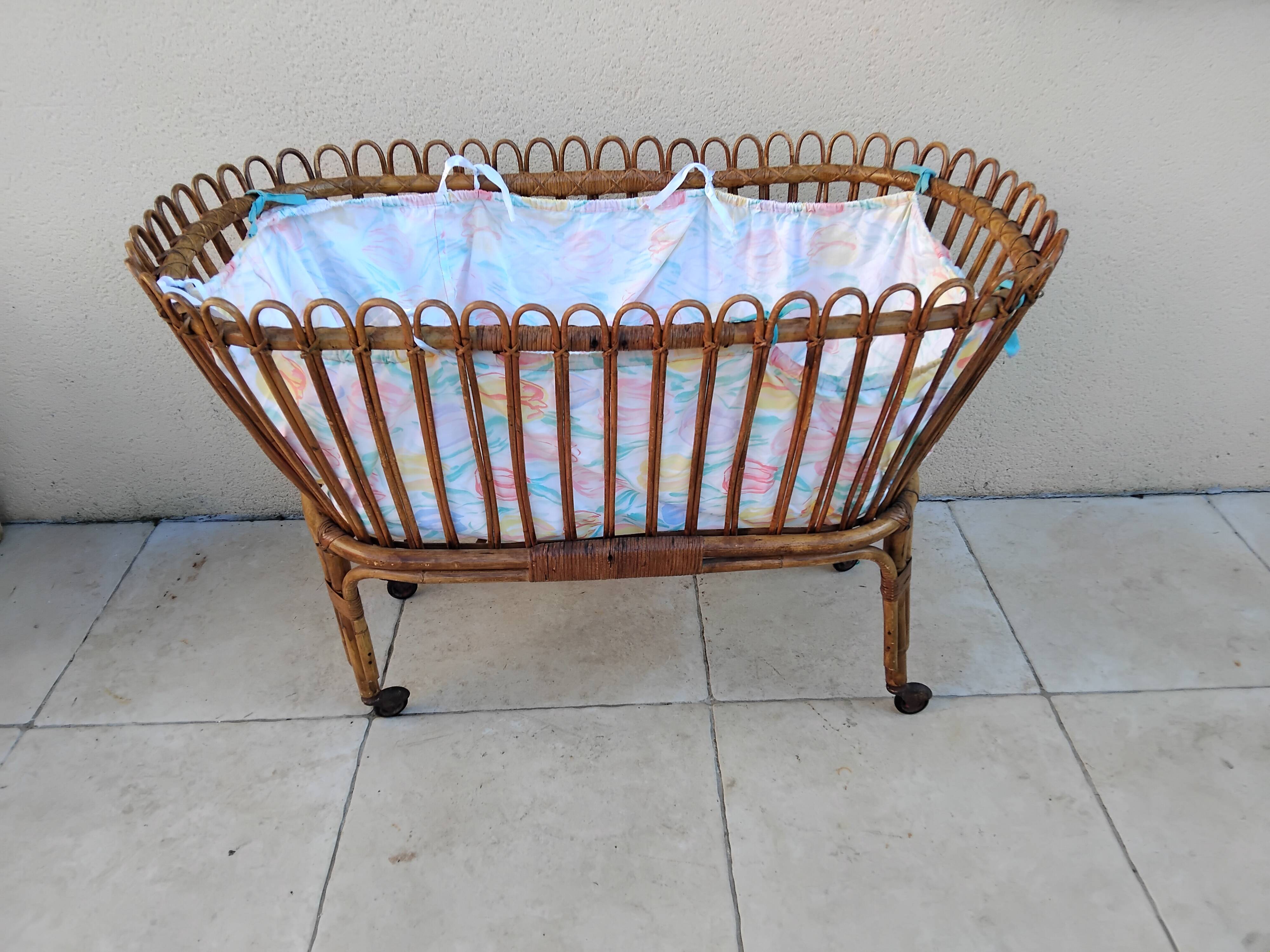 Vintage rattan bed on wheels cradle