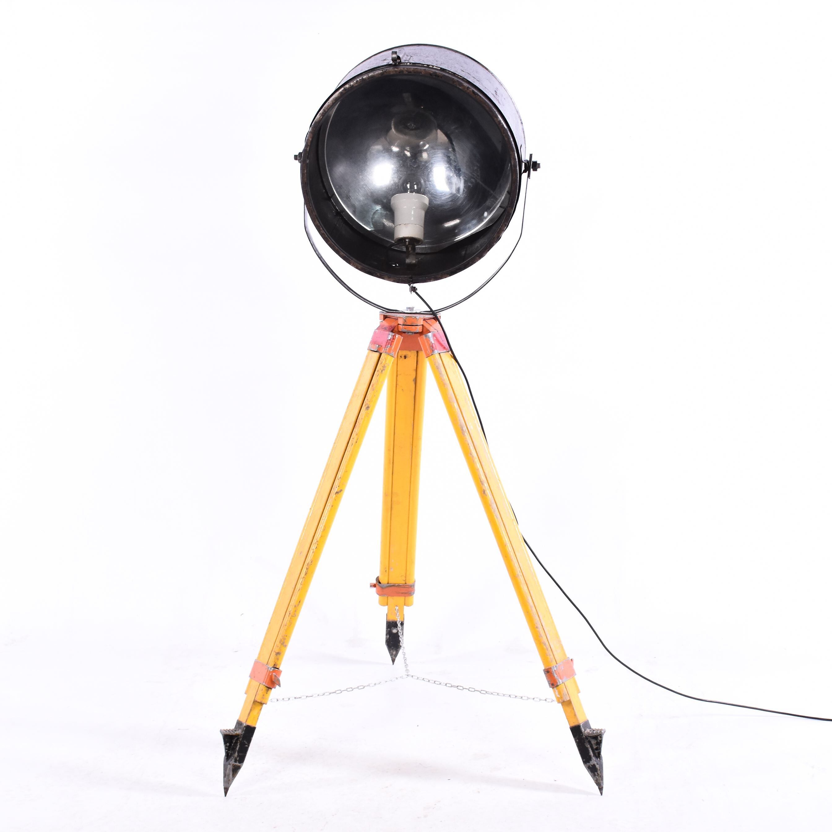 Old industrial spot on wooden tripod