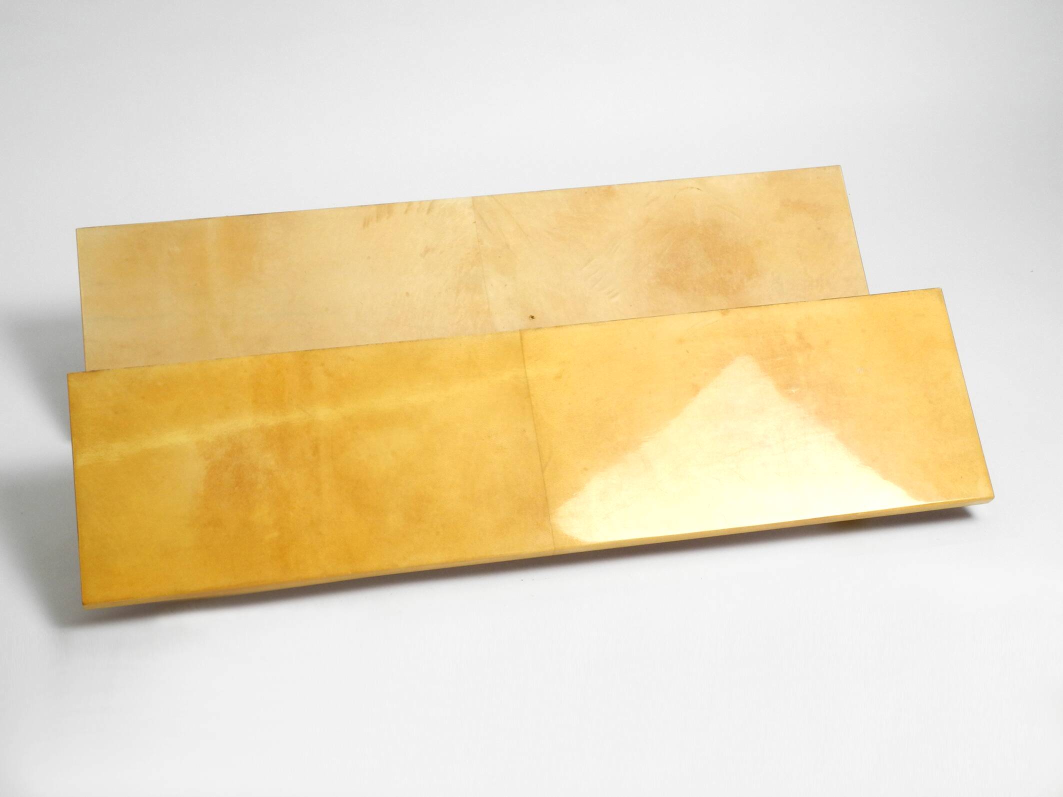 Two 1960s large Aldo Tura shelves made of wood and goatskin in beige