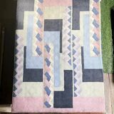 Hand-knotted wool rug by Tisca with a geometric pattern, signed "ILES", France, 1990s.