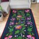 Handwoven summerish floral rug, black background with colorful delicate flowers 152x238cm