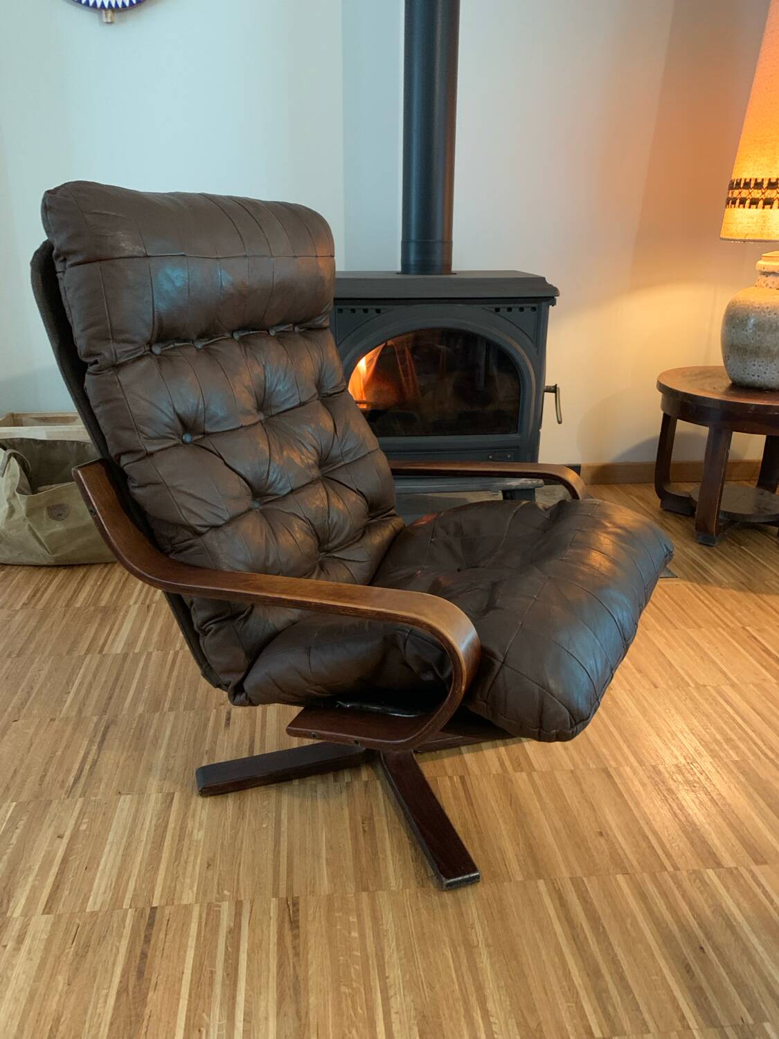 Vintage leather armchair with wooden armrests