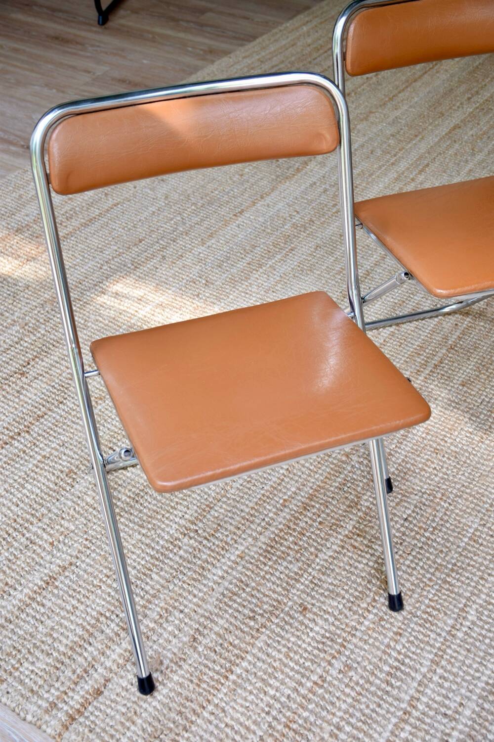 Pair of “Soudexvinyl” folding chairs in skai and chrome tube