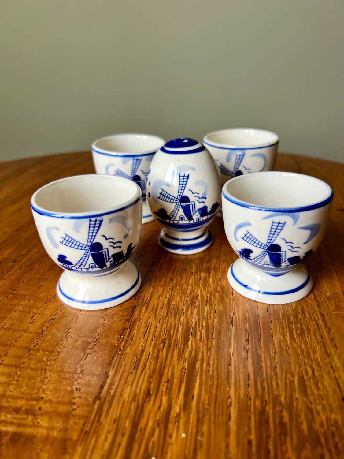 Set of 4 vintage egg cups and salt shaker in blue Delft pottery.