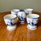 Set of 4 vintage egg cups and salt shaker in blue Delft pottery.