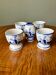 Set of 4 vintage egg cups and salt shaker in blue Delft pottery.
