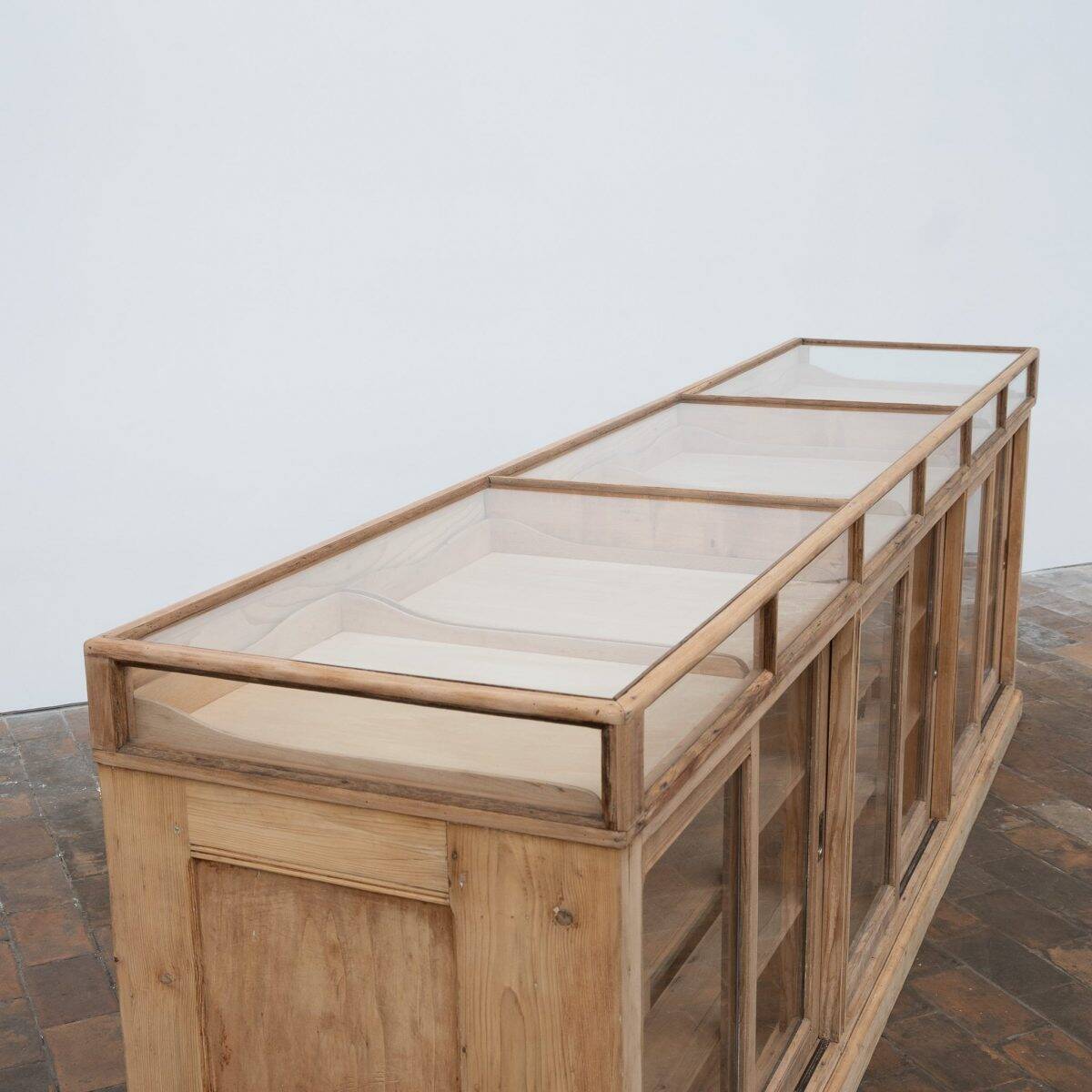 Old glass-fronted pine trade counter - early 20th century
