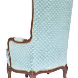 Pair of Louis XV style wingback armchairs with five legs.