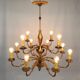 Golden luster with 12 arms of light decorated with leaves 1940