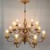 Golden luster with 12 arms of light decorated with leaves 1940