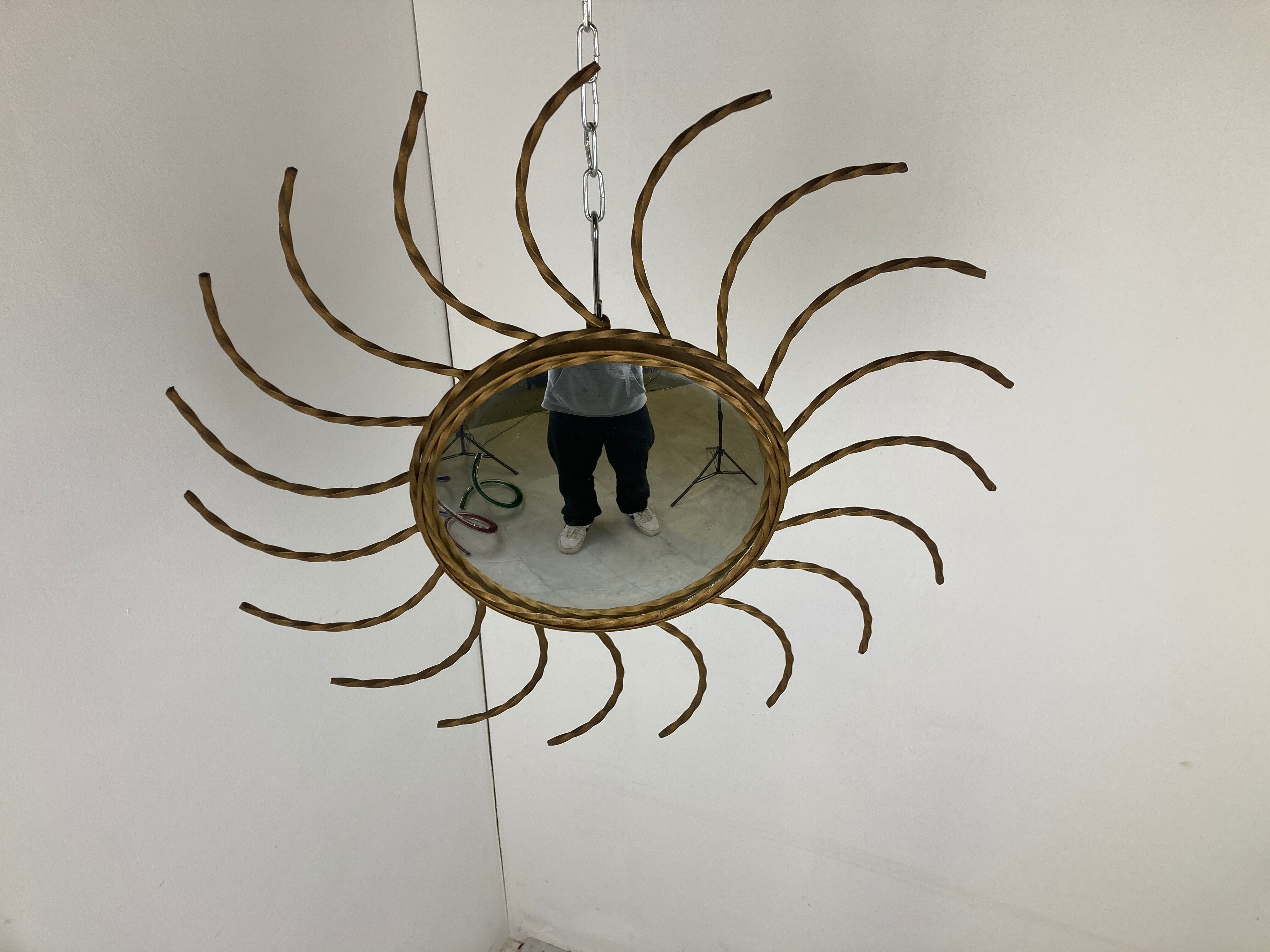 Mid century gold sunburst mirror with convex glass.