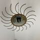Mid century gold sunburst mirror with convex glass.