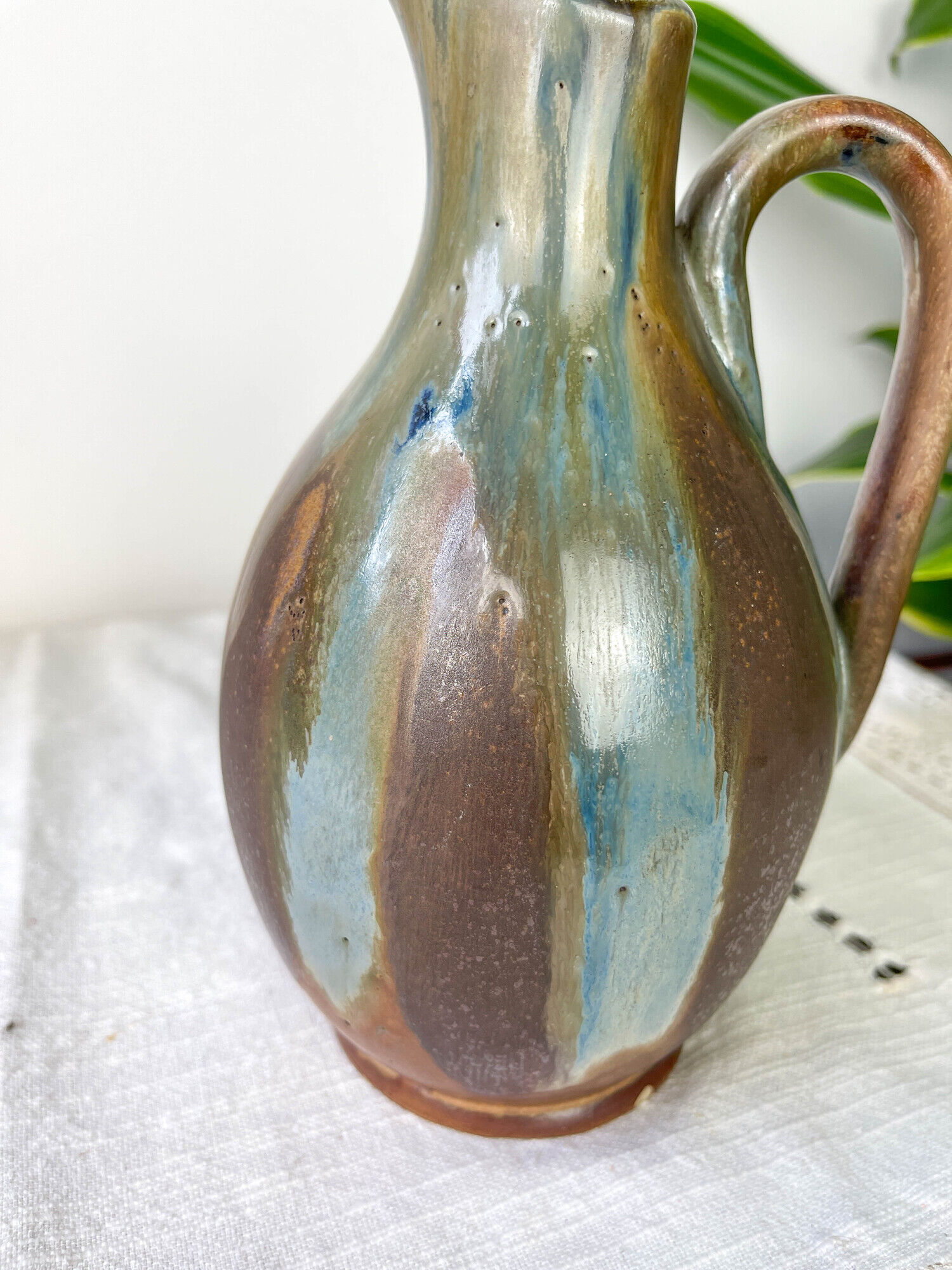 Art Nouveau style carafe in flamed stoneware with blue and brown drips