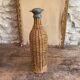 Woven wicker bottle