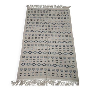 Handmade white and blue rug made of natural wool