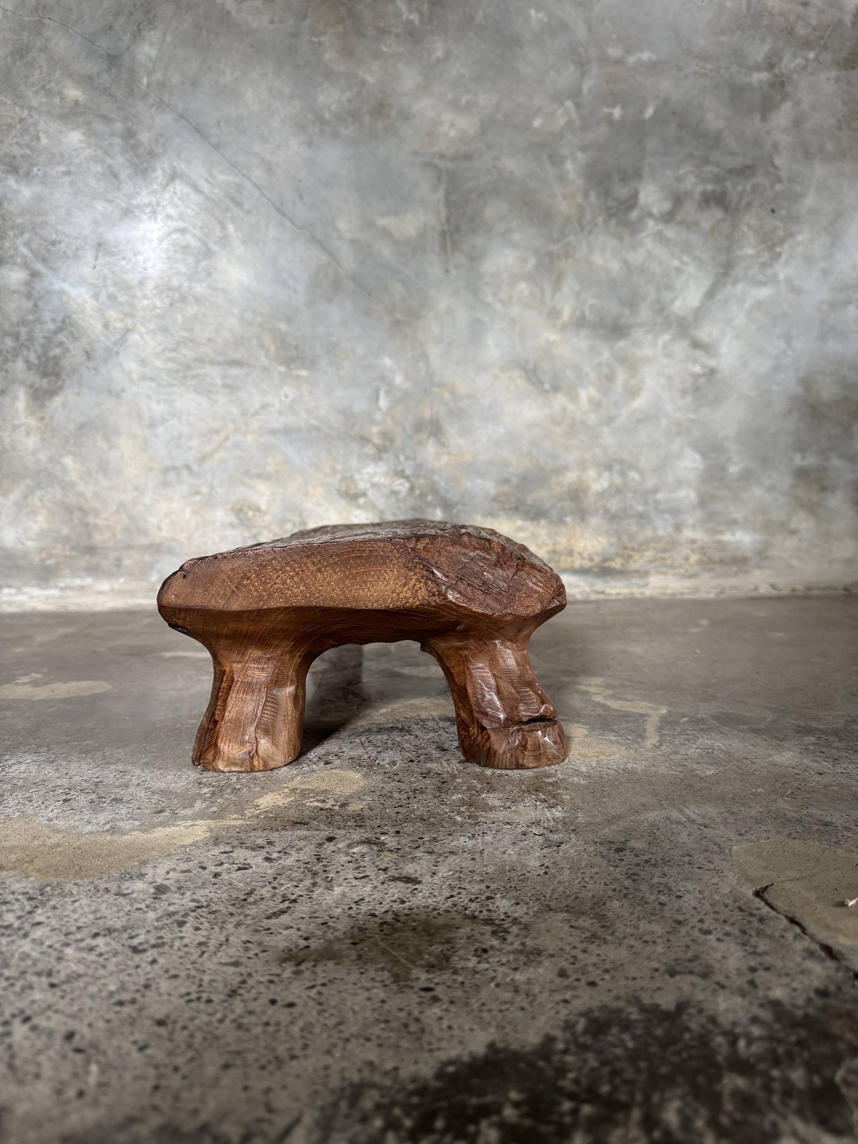 Small stool, footrest in blond teak, organic monoxyle with cut corners.