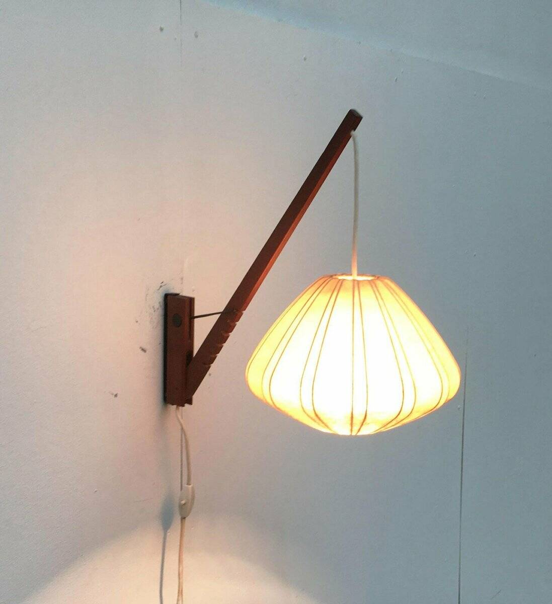 Mid-century pivoting wall lamp with a swing arm, Cocoon, made of teak wood, 1960s.