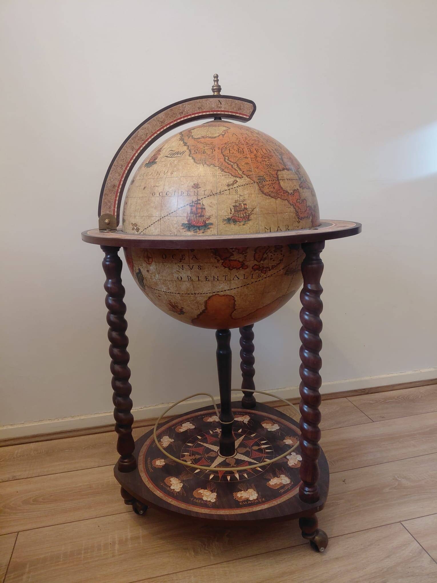 Vintage globe bar with storage for bottles and glasses.