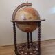 Vintage globe bar with storage for bottles and glasses.