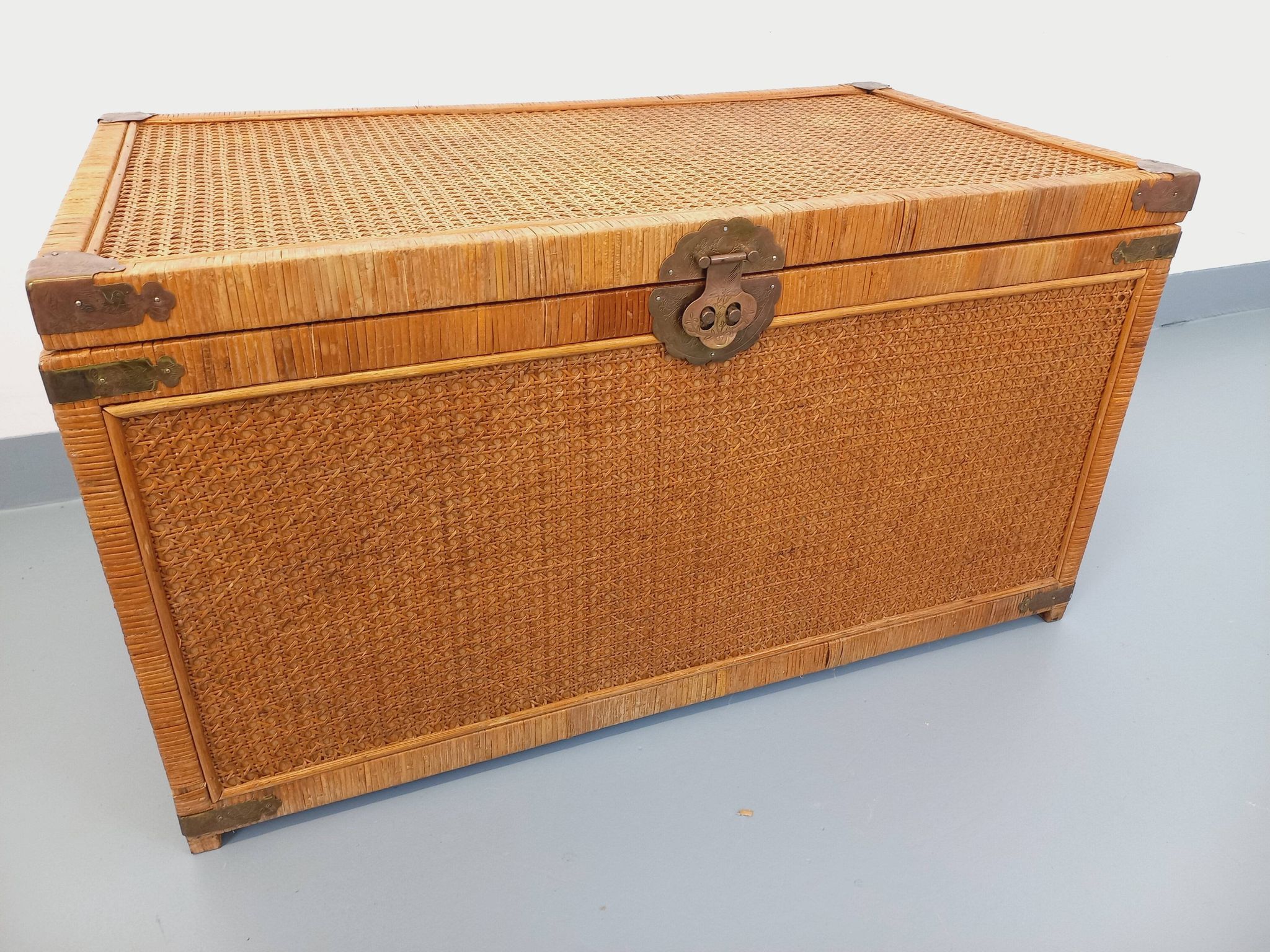 Vintage trunk in wood, rattan, caning, and brass.