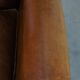 Sheepskin wing chair + XXL patinated footrest