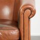 Vintage sheepskin club armchair with a warm colour scheme with black piping